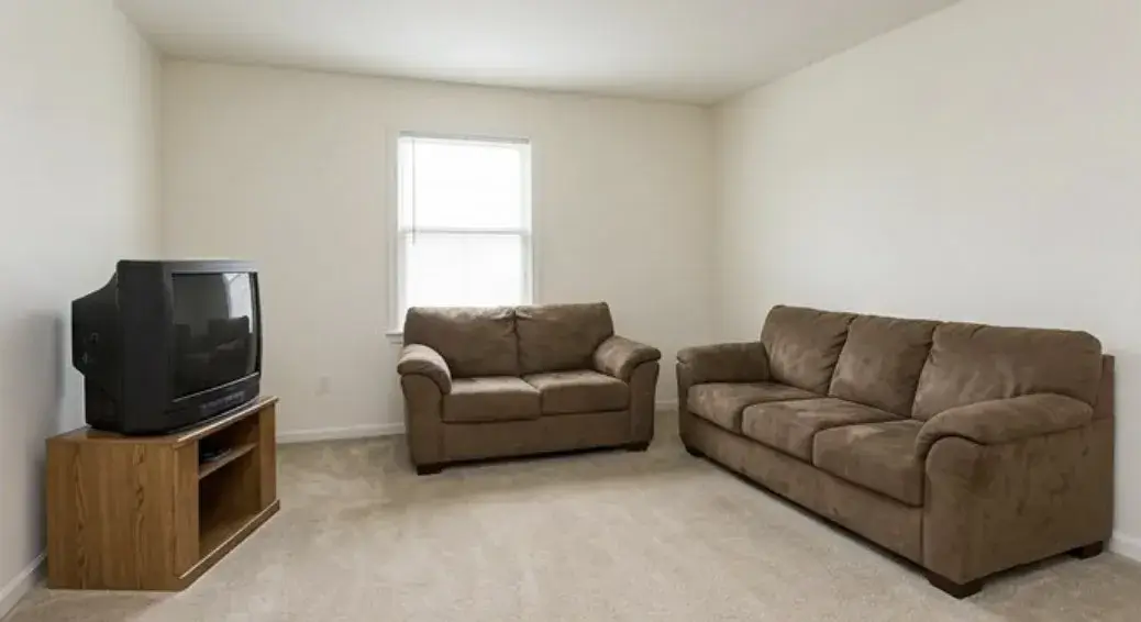 Bare room — brown sofa, nothing else